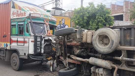 A tipper filled with gravel overturned on Landran road near Adarsh Nagar, Kharar, on Sunday after the driver had to apply emergency brakes to avoid collision with a Hyundai i-20 car but got hit by another truck from the rear side. (HT Photo)