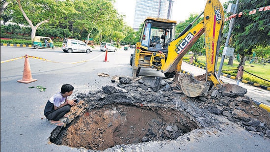 The sinkhole on Ashoka Road on Sunday. (PTI)