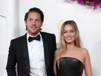 Tom Ackerley, left, and Margot Robbie arrive at the Oscars on Sunday, March 10, 2024, at the Dolby Theatre in Los Angeles.(Jordan Strauss/Invision/AP)