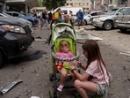 Children wait near the site of Okhmatdyt children’s hospital hit by Russian missiles, in Kyiv, Ukraine, Monday, July 8, 2024. Russian missiles have killed at least seven people and struck a children’s hospital in the Ukrainian capital, Kyiv, authorities say. (AP Photo/Evgeniy Maloletka)