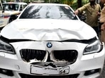 Police personnel inspect a BMW car that ran over two people riding a bike, at Worli Police Station in Mumbai on Sunday. One woman died and one person injured in the accident. Police personnel inspect a BMW car that ran over two people riding a bike, at Worli Police Station in Mumbai on Sunday. One woman died and one person injured in the accident.