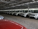 Cars are seen parked under solar panels at the manufacturing plant of Maruti Suzuki in Manesar.