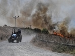 Fires blaze near a road, after Lebanon's Hezbollah said it launched more than 200 rockets and a swarm of drones at Israeli military sites, in the Israeli-occupied Golan Heights 
