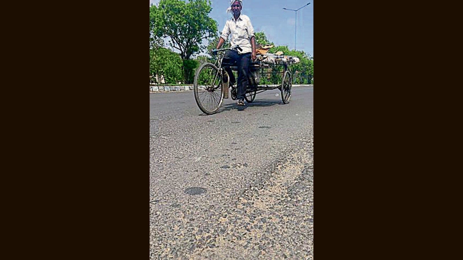 Re-carpeted last October, 200-ft road develops potholes, cracks