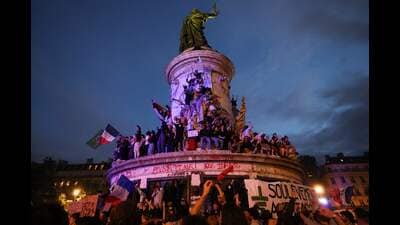 Participants wave French national tricolors during an election night rally following the first results of the second round of France's legislative election at Place de la Republique in Paris on July 7, 2024. (Photo by Emmanuel Dunand / AFP) (AFP) Participants wave French national tricolors during an election night rally following the first results of the second round of France's legislative election at Place de la Republique in Paris on July 7, 2024. (Photo by Emmanuel Dunand / AFP) (AFP)