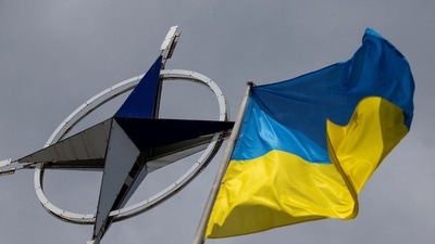 A Ukrainian national flag is pictured in front of the NATO emblem (REUTERS file photo)