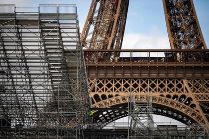 Workers build the Eiffel Tower Stadium that will host the Beach Volleyball and men's Blind Football competitions during the upcoming Paris 2024 Olympics on April 3, 2024 in the Champ-de-Mars garden in Paris. (AFP) Workers build the Eiffel Tower Stadium that will host the Beach Volleyball and men's Blind Football competitions during the upcoming Paris 2024 Olympics on April 3, 2024 in the Champ-de-Mars garden in Paris. (AFP)
