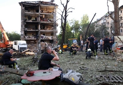 Rescuers rest as they work near apartment buildings and a kindergarten destroyed by a missle strike in Kyiv, on July 8, 2024, amid the Russian invasion of Ukraine. Russia struck cities across Ukraine on July 8, 2024, with a missile barrage that killed 33 people and ripped open a children's hospital in Kyiv. (AFP) Rescuers rest as they work near apartment buildings and a kindergarten destroyed by a missle strike in Kyiv, on July 8, 2024, amid the Russian invasion of Ukraine. Russia struck cities across Ukraine on July 8, 2024, with a missile barrage that killed 33 people and ripped open a children's hospital in Kyiv. (AFP)