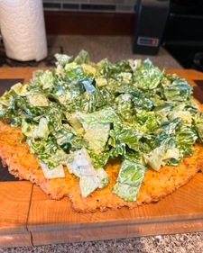 Caesar salad on a chicken pizza (Instagram)