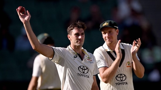 Australian bowler Pat Cummins (L) acknowledges the applause after taking five wickets on the fourth day of the second cricket Test vs Pakistan