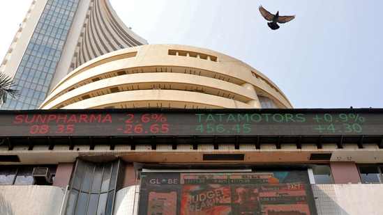 Stock market today: A bird flies past a screen displaying the Sensex results on the facade of the Bombay Stock Exchange (BSE) building in Mumbai.(Reuters)