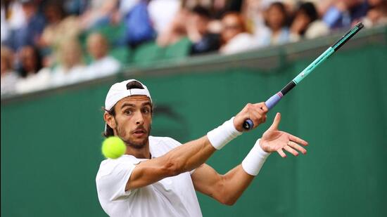 Italy's Lorenzo Musetti returns the ball to France's Giovanni Mpetshi Perricard. (AFP)