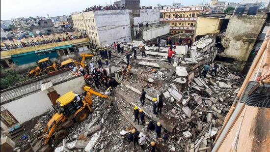 JCB machines remove the debris after a four-storey building collapsed in Surat on Sunday. (ANI Photo)