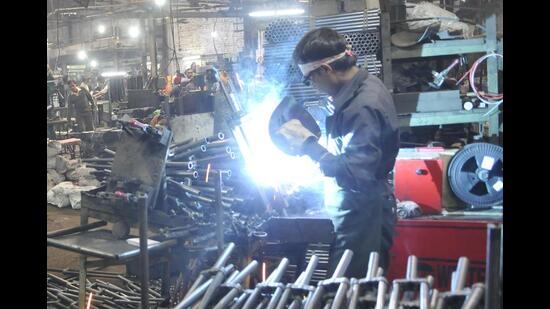 Ludhiana, India - 23, 2019 : Industry workers working on Machine in a Auto parts industry in Ludhiana August 23, 2019. (Photo Hindustan Times)