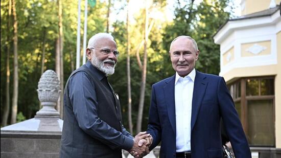 Prime Minister Narendra Modi and Russia President Vladimir Putin shake hands during an informal meeting at Novo-Ogarevo state residence, outside Moscow, Russia, on Monday. (AP)