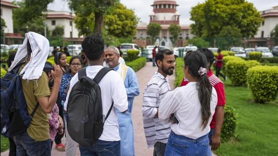 Students and others at the Supreme Court on Monday as the court began to hear petitions regarding the alleged irregularities in the administration of NEET UG 2024 exams. (PTI photo)