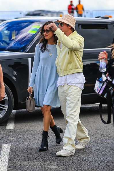 Ines de Ramon and Brad Pitt hold hands at the British Grand Prix.