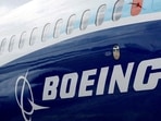 FILE PHOTO: The Boeing logo is seen on the side of a Boeing 737 MAX at the Farnborough International Airshow, in Farnborough, Britain, July 20, 2022.  REUTERS/Peter Cziborra/File Photo