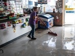 A worker sweeps water from a damaged convenience store after Hurricane Beryl made landfall in Palacios, Texas, US.(Bloomberg) A worker sweeps water from a damaged convenience store after Hurricane Beryl made landfall in Palacios, Texas, US.(Bloomberg)