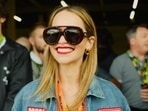 Game of Thrones star Emilia Clarke flashed a big smile as she made a surprise appearance at the F1 British Grand Prix. 