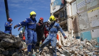 Rescuers carry the body of a person found under debris at the site where an apartment building was hit by a Russian missile strike, amid Russia's attack on Ukraine, in Kyiv, Ukraine July 9, 2024. Press service of the State Emergency Service of Ukraine (via REUTERS)