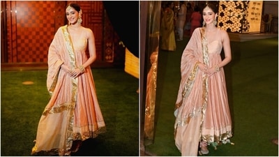 Ananya Panday wore a blush pink anarkali suit set to Anant Ambani and Radhika Merchant's Haldi ceremony. Her sleeveless anarkali kurta features a deep V neckline, a pleated flared skirt, a gota-embroidered border, and a cinched bust. She styled the kurta with a matching dupatta and churidar pyjamas. (Instagram) Ananya Panday wore a blush pink anarkali suit set to Anant Ambani and Radhika Merchant's Haldi ceremony. Her sleeveless anarkali kurta features a deep V neckline, a pleated flared skirt, a gota-embroidered border, and a cinched bust. She styled the kurta with a matching dupatta and churidar pyjamas. (Instagram)