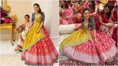 Radhika Merchant's elder sister, Anjali Merchant, attended the Haldi function in a multi-coloured silk lehenga set custom-designed by the fashion house Jayanti Reddy. She wore a purple deep-neck blouse styled with a contrasting pink brocade lehenga and a yellow embroidered dupatta. (Instagram) Radhika Merchant's elder sister, Anjali Merchant, attended the Haldi function in a multi-coloured silk lehenga set custom-designed by the fashion house Jayanti Reddy. She wore a purple deep-neck blouse styled with a contrasting pink brocade lehenga and a yellow embroidered dupatta. (Instagram)