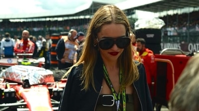 Emilia Clarke opted for a green dress that was styled as if it were pants with a belt, and paired it with a black jacket on top. 