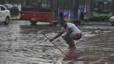 A man tries to unclog the drain. Isolated light rain to continue in the region in the next few days, said IMD. (Raj K Rak/HT Photo) A man tries to unclog the drain. Isolated light rain to continue in the region in the next few days, said IMD. (Raj K Rak/HT Photo)