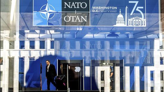 A Nato summit attendee walks through the Walter E Washington Convention Center in Washington, on Tuesday. (AP)