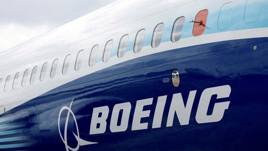 FILE PHOTO: The Boeing logo is seen on the side of a Boeing 737 MAX at the Farnborough International Airshow, in Farnborough, Britain, July 20, 2022. REUTERS/Peter Cziborra/File Photo(REUTERS)