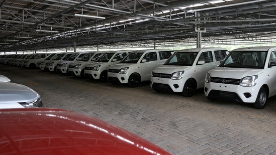 Cars are seen parked under solar panels at the manufacturing plant of Maruti Suzuki in Manesar.(Reuters)