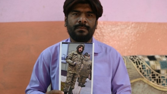 In this photo taken on February 22, 2024, Mohammed Imran shows his brother Mohammed Asfan image who was stranded in Russia along the war torn Ukraine border, at their home in Hyderabad. An apple farmer, an airline caterer and an out-of-work graduate are among the Indian nationals hired by Moscow, with the help of recruiters around the world, for the Russian Army in Ukraine.(AFP file)