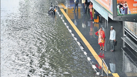 People (above) walk amid rain at Kartavya Path on Tuesday; Commuters at a waterlogged bus top at ITO. (Raj K Raj/Arvind Yadav/HT) People (above) walk amid rain at Kartavya Path on Tuesday; Commuters at a waterlogged bus top at ITO. (Raj K Raj/Arvind Yadav/HT)