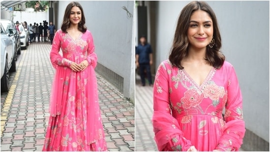 Mrunal Thakur dazzled at an event in Mumbai today in a printed pink anarkali set styled with an embroidered dupatta. She styled the ensemble with jhumkis, a ring, centre-parted loose locks, and minimal glam.&nbsp;(HT Photo/Varinder Chawla)