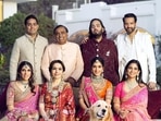Mukesh Ambani, Nita Ambani, Isha Ambani, Anand Piramal, Anant Ambani, Radhika Merchant, Shloka Mehta and Akash Ambani pose for a family photo during pre-wedding celebrations of Anant and Radhika in Jamnagar in March.