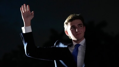 Barron Trump waves as his father, Republican presidential candidate former President Donald Trump, speaks at a campaign rally at Trump National Doral Miami, Tuesday, July 9, 2024, in Doral, Fla. (AP Photo/Rebecca Blackwell) (AP) Barron Trump waves as his father, Republican presidential candidate former President Donald Trump, speaks at a campaign rally at Trump National Doral Miami, Tuesday, July 9, 2024, in Doral, Fla. (AP Photo/Rebecca Blackwell) (AP)