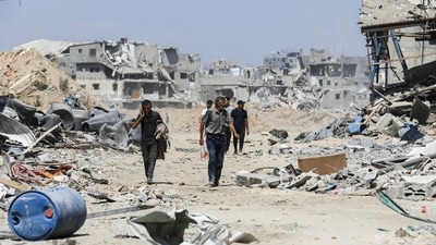 Palestinians make their way as they inspect the damage, after Israeli forces withdrew from Shejaiya neighborhood, following a ground operation, amid Israel-Hamas conflict, in eastern part of Gaza city, July 10, 2024. (Reuters)
