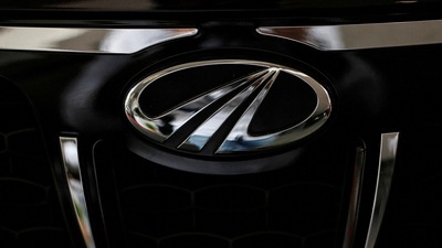 Mahindra & Mahindra share price: The logo of Mahindra and Mahindra is seen on a car at a showroom in Mumbai, India. (Reuters)