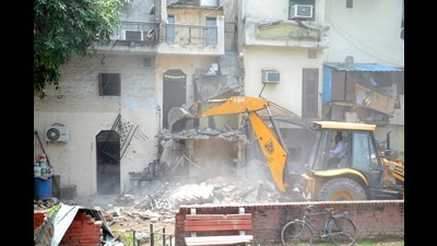 MC teams removing encroachments at the Bapu Dham Colony on Wednesday. (Ravi Kumar/ht)