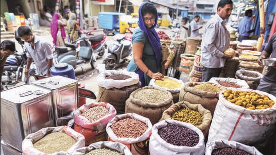 A customer shops for pulses in a store at a local market (Bloomberg File)