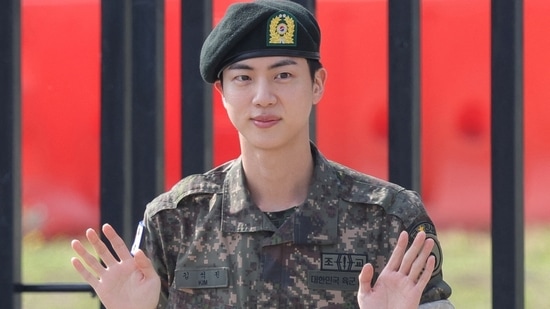 BTS member Jin posed for photographs after being discharged from the military in Yeoncheon, South Korea.(via REUTERS)