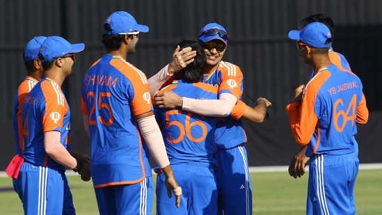 India's Ravi Bishnoi (C) celebrates with teammates after claiming a sensational catch of Sikandar Raza.(AFP)