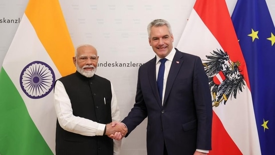 Prime Minister Narendra Modi being greeted by Austrian Chancellor Karl Nehammer, in Vienna, Austria, Wednesday. (PTI)