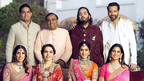 Mukesh Ambani, Nita Ambani, Isha Ambani, Anand Piramal, Anant Ambani, Radhika Merchant, Shloka Mehta and Akash Ambani pose for a family photo during pre-wedding celebrations of Anant and Radhika in Jamnagar in March. 