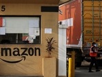 A man inspects trucks before they enter an Amazon storage facility on the outskirts of Mumbai, India. A man inspects trucks before they enter an Amazon storage facility on the outskirts of Mumbai, India.