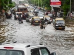 Commuters wade through a waterlogged road at Dadar after a monster thunderstorm caused heavy rains in Mumbai and adjoining areas on Monday Commuters wade through a waterlogged road at Dadar after a monster thunderstorm caused heavy rains in Mumbai and adjoining areas on Monday