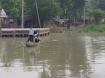 People moving to a safer place in boat after their village was flooded by Sharda river in Kheri’s Dhaurahra tehsil on July 11. (HT photo) People moving to a safer place in boat after their village was flooded by Sharda river in Kheri’s Dhaurahra tehsil on July 11. (HT photo)