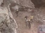 Workers clearing debris on the Badrinath Highway narrowly escaped when boulders fell near them.(X) Workers clearing debris on the Badrinath Highway narrowly escaped when boulders fell near them.(X)