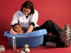 20-year-old Lionel Messi bathing Lamine Yamal, who was merely six months old at the time, during a photo session in the dressing room of the Camp Nou stadium in Barcelona, Spain, in September 2007. 20-year-old Lionel Messi bathing Lamine Yamal, who was merely six months old at the time, during a photo session in the dressing room of the Camp Nou stadium in Barcelona, Spain, in September 2007.